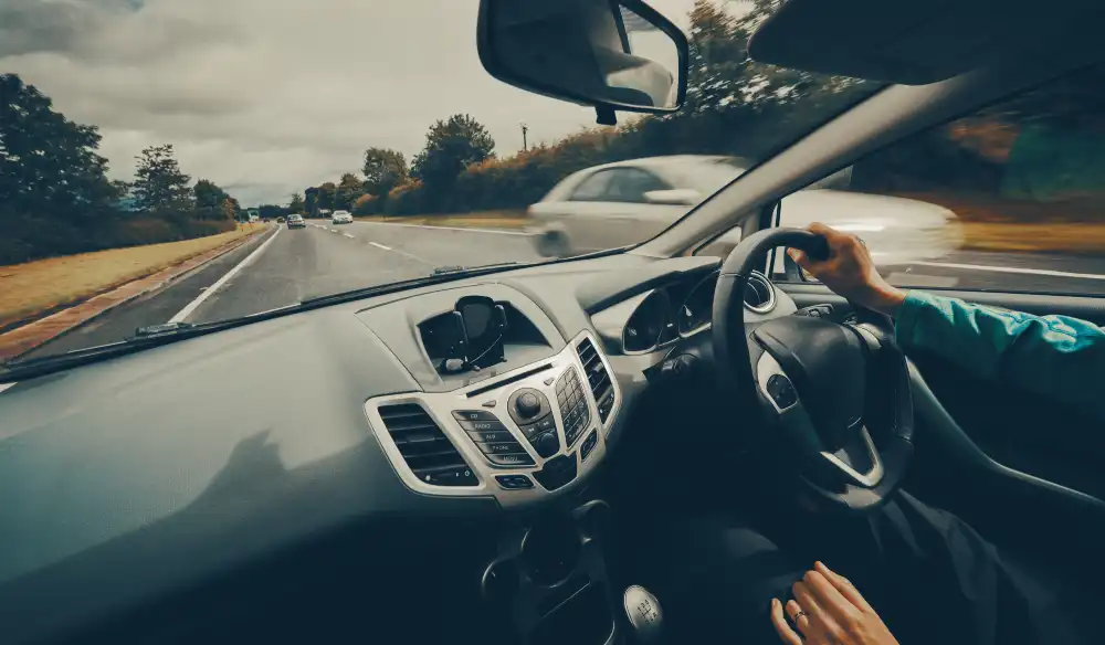 Mobile notary service represented by a man driving a car.